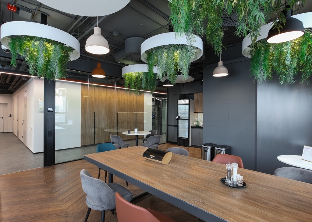 Pantry breakout with hanging planters and communal dining table