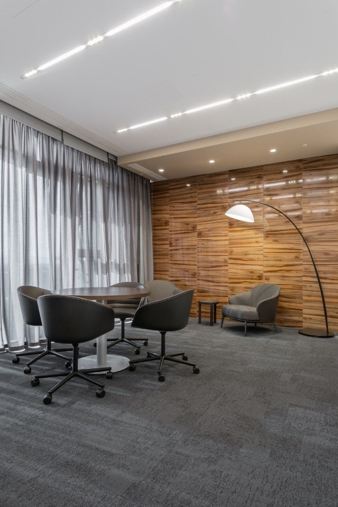 Executive lounge with meeting table and wood feature wall