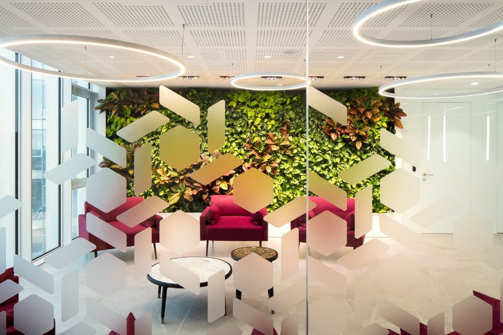 Lounge area viewed through geometric glass partition