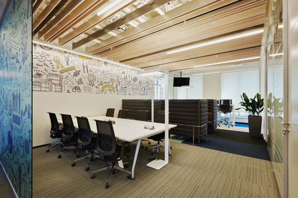Conference room with illustrated feature wall and wood-slat ceiling