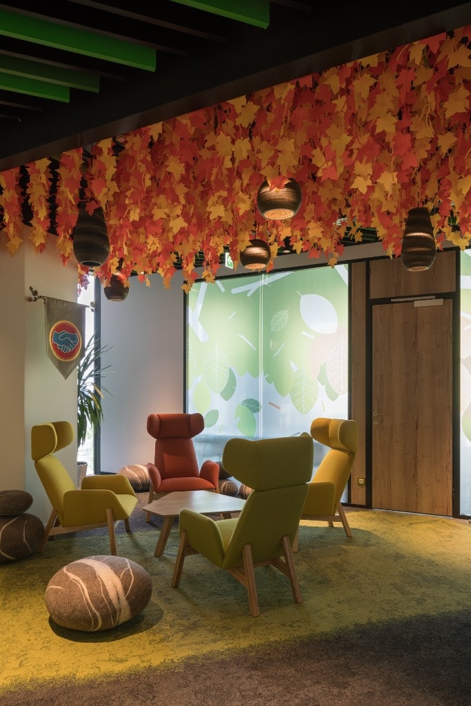 Breakout nook with autumn leaf canopy and lime-green chairs