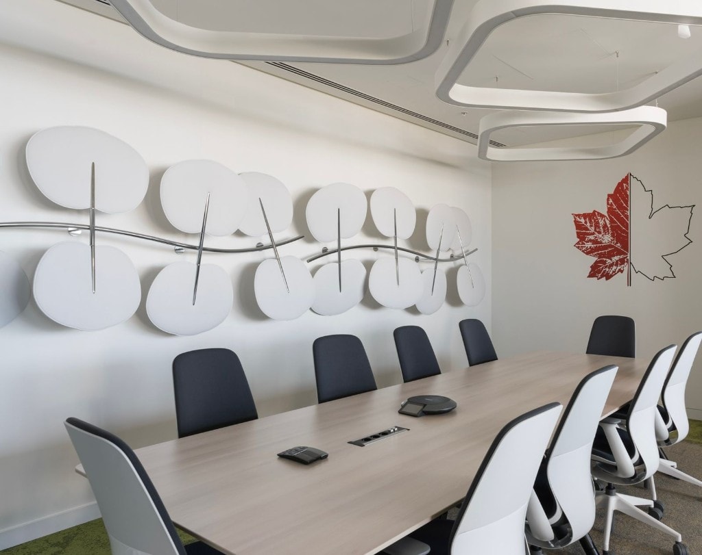 Conference room with sculptural wall art and geometric pendant lights