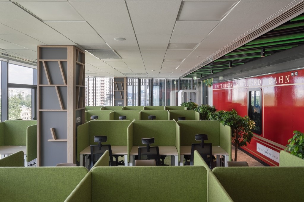 Themed workspace with Matterhorn train wall and green workstations
