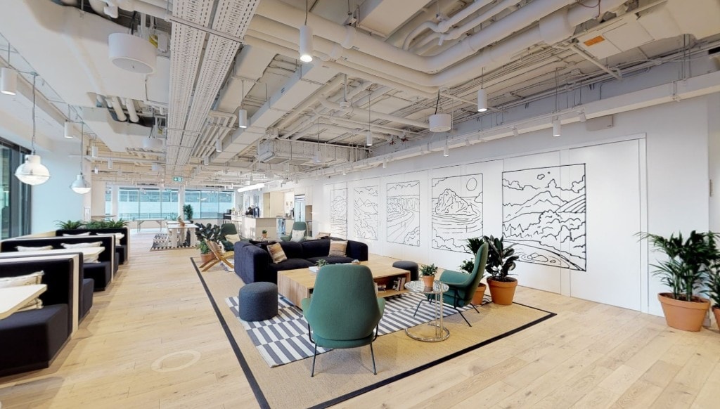 Open lounge with booth seating and exposed industrial ceiling