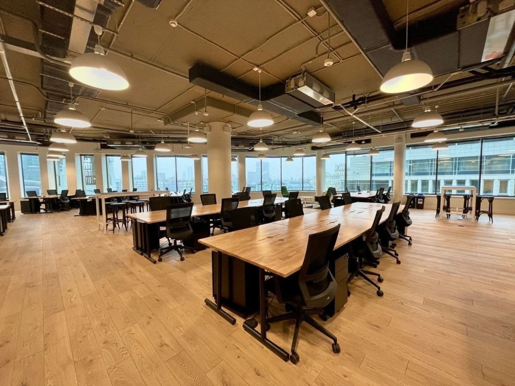 Open workspace with curved windows and dome pendant lighting