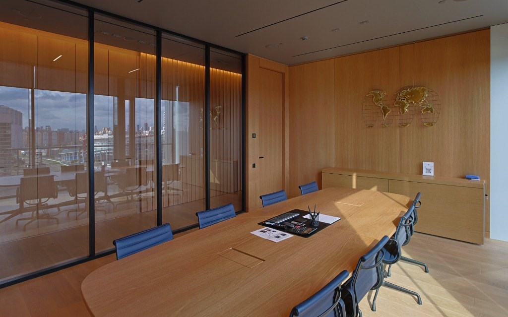Conference room with wood panel wall and red accent door